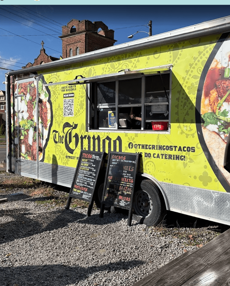 Modern food truck serving gourmet street food at an outdoor festival with 'Everyday Getaway' branding
