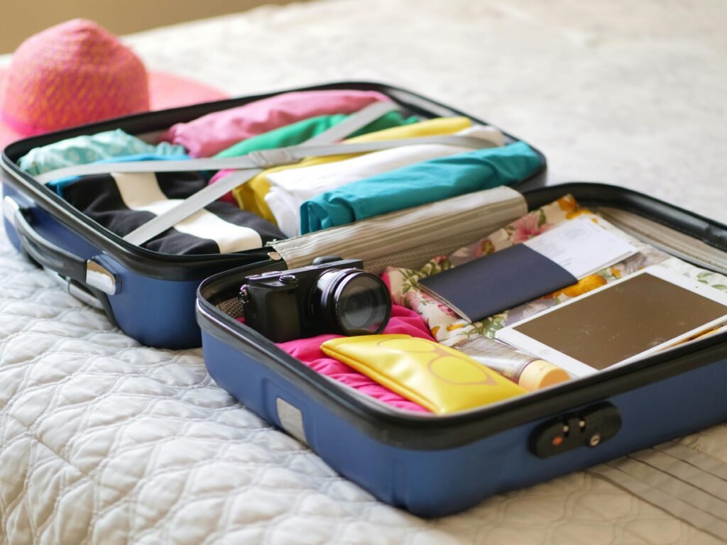 A suitcase featuring a minimalist travel packing list with organized compression cubes and neutral travel capsule wardrobe essentials.