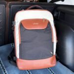 LOVELOOK 40L travel backpack placed on a car seat, showing compact personal item size that is Spirit and Frontier approved with a structured design and multiple compartments.