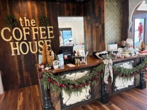 Inside The Coffee House of Plymouth showing the cozy counter area decorated with greenery and seasonal décor. A Relaxing coffee shop.