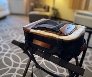 Lovelook 40L travel backpack sitting open on a luggage rack in a hotel room, ready for an overnight packing list check.