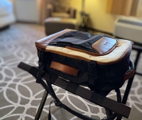Lovelook 40L travel backpack sitting open on a luggage rack in a hotel room, ready for an overnight packing list check.