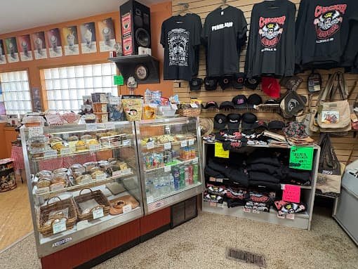Exterior of Checker Records in Hillsdale, Michigan, a relaxing coffee shop and vintage record store with red siding and outdoor seating.
