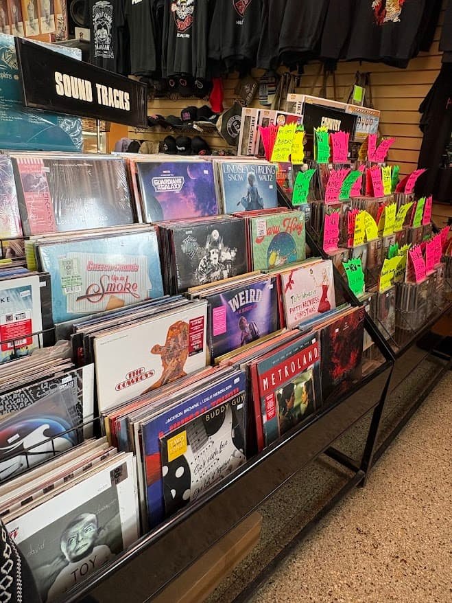Rows of vinyl records on display at Checker Records in Hillsdale, Michigan, featuring soundtracks and classic albums with neon price tags.