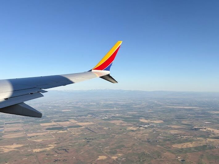 view out the window of a plane in flight. Flying to a great vacation Don't forget a vacation packing list