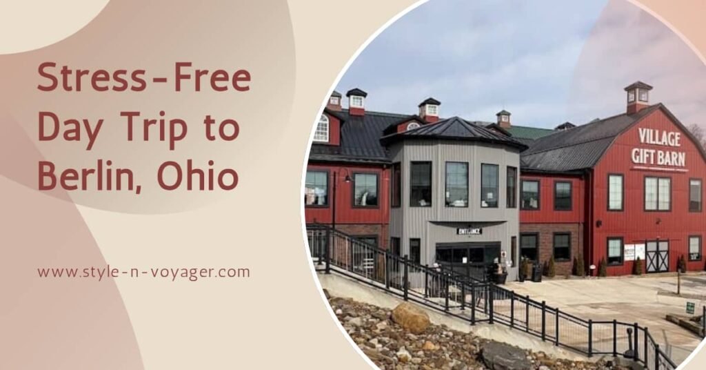 A blog feature image for a stress-free day trip to Berlin, Ohio. The graphic shows the red exterior of the Village Gift Barn with the text "Stress-Free Day Trip to Berlin, Ohio" on a tan background.