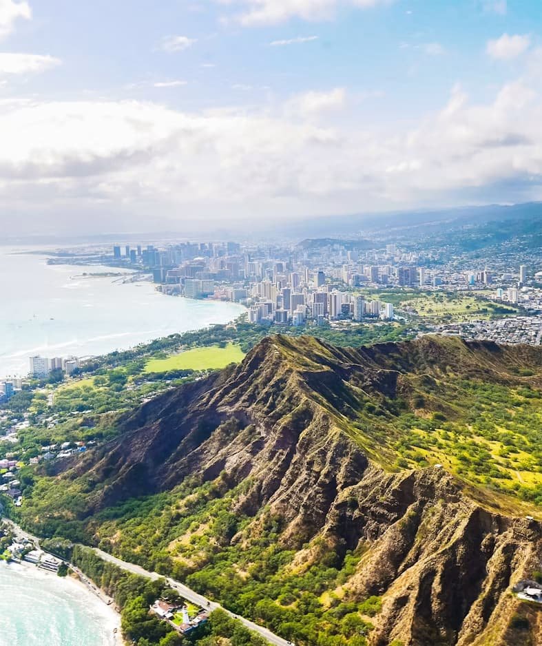 Aerial view of Diamond Head crater with Waikiki skyline and Pacific Ocean in the background — the most iconic hike on a 3-day Oahu itinerary