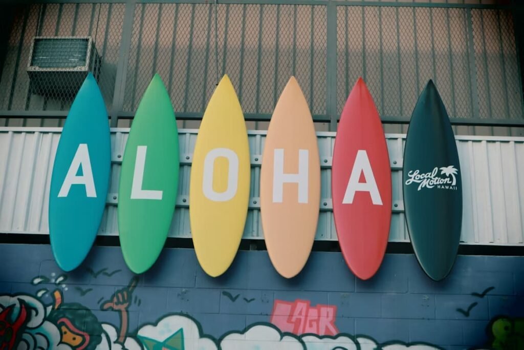 Colorful surfboards spelling ALOHA on a wall at Local Motion Hawaii shop in Haleiwa — a classic North Shore Oahu photo stop
