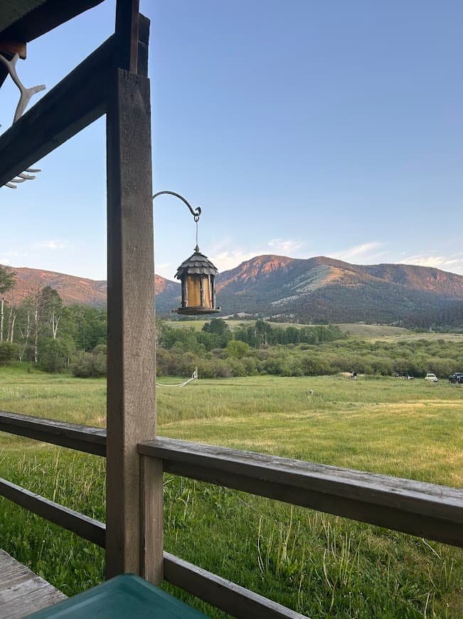 Scenic mountain view from a mountain cabin VRBO back porch in Gardiner Montana. This is a great tip to Plan a Yellowstone Trip from Gardiner.