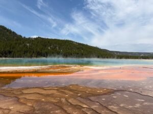 Grand Prismatic Spring close up view from the boardwalk in Yellowstone during a clear summer day. Plan a Yellowstone Trip from Gardiner