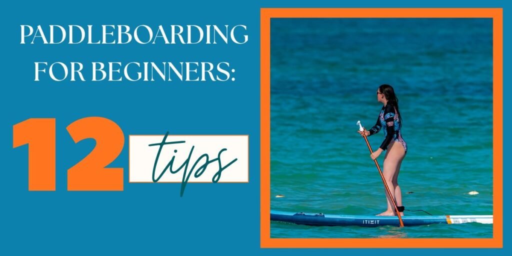 Graphic design with a blue background and orange accents featuring the text "Paddleboarding for Beginners: 12 Tips." On the right side, an image shows a woman in a long-sleeve rashguard swimsuit standing and balanced on a blue inflatable stand-up paddleboard on bright turquoise water.