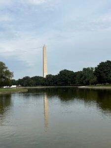 Vertical view of the Washington Monument and its clear reflection across the water of the Constitution Gardens Pond on a summer day in Washington, DC